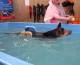 Hunter swimming after surgery with her new buoyancy aids at dog swim spa